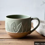 핸드메이드 도자기 브랜드 - A handcrafted ceramic cup inspired by Siberian nature, featuring delicate hand-carved patterns of le...